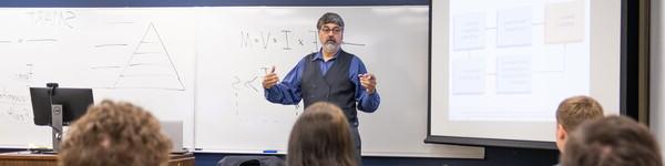 Professor Greg Hardt teaches in front of the class.