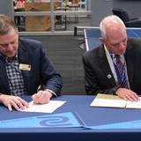 Dr. Paul Illich, SCC president, and Bill Motzer, vice president for enrollment management at NWU, sign the Biotechnology Pathway Agreement.